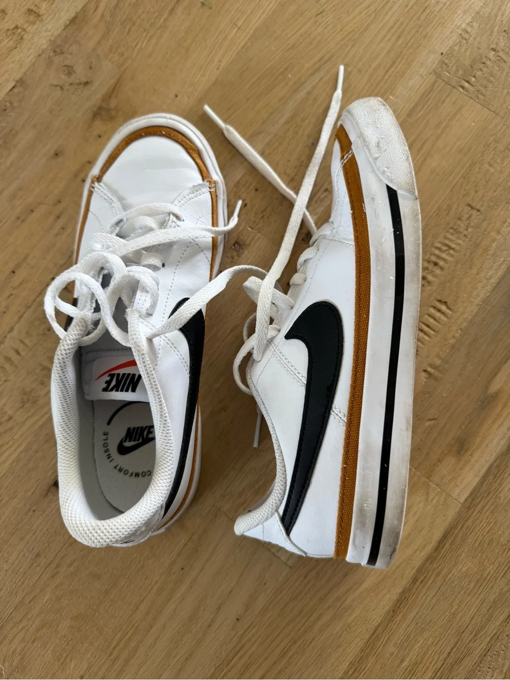 Nike Kids White Sneakers with Black Swoosh and Brown Trim